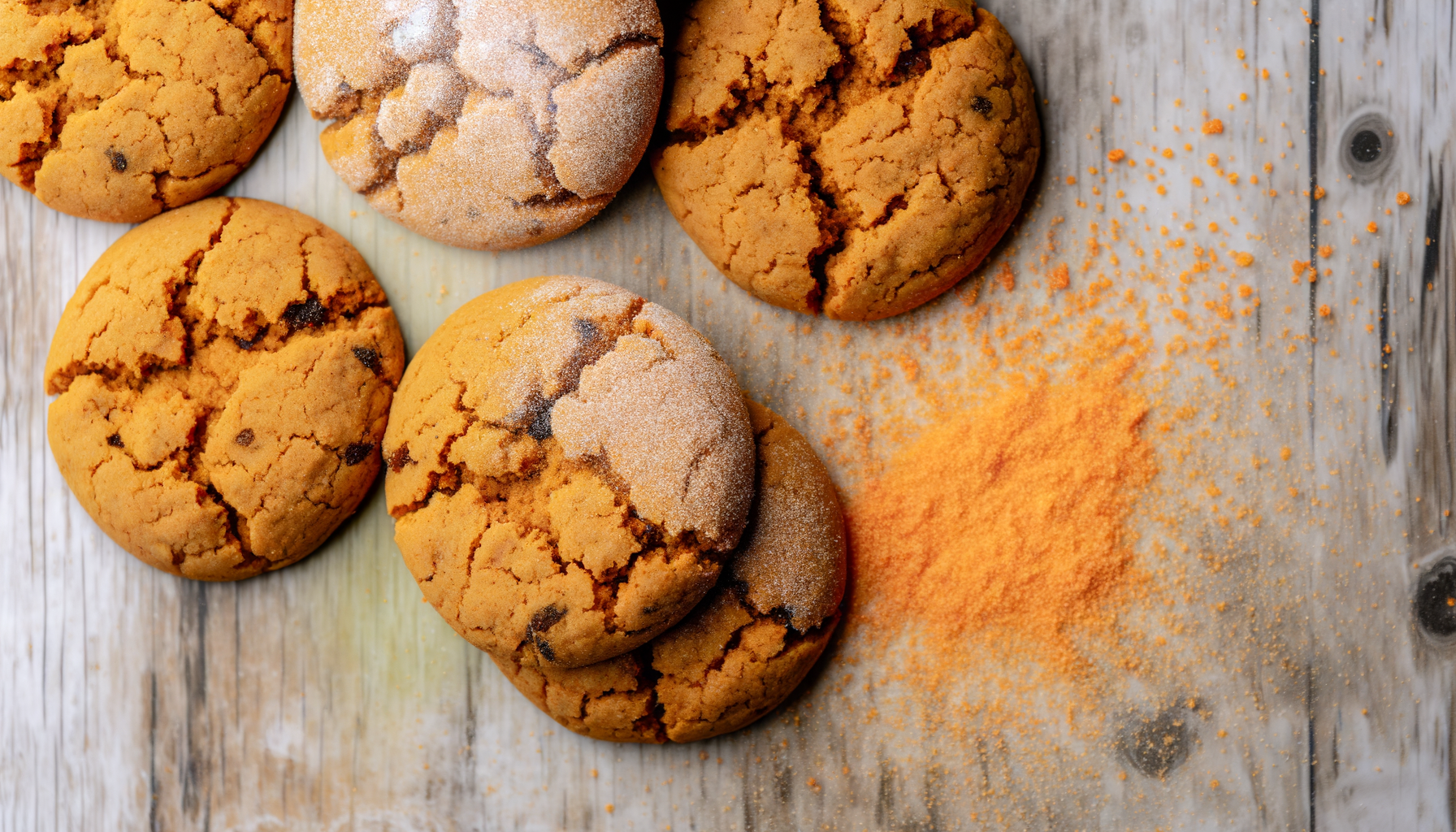 Homemade Big Soft Ginger Cookies, dusted with sugar, offer a spicy bite with a sweet finish on a rustic table.